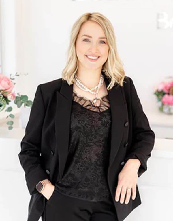 a woman wearing a suit and tie